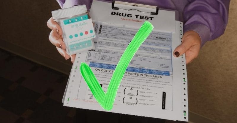 woman holding drug test clipboard with specimen cup and green check mark over it